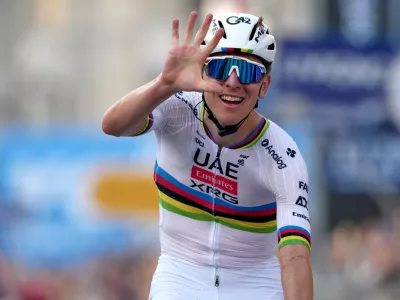 Reigning World Champion Tadej Pogacar indicates five as he celebrates winning his fifth in a row Il Lombardia, Tour of Lombardy cycling race, in Bergamo, Italy, Saturday, Oct. 11, 2025. (Gian Mattia D'Alberto/LaPresse via AP)