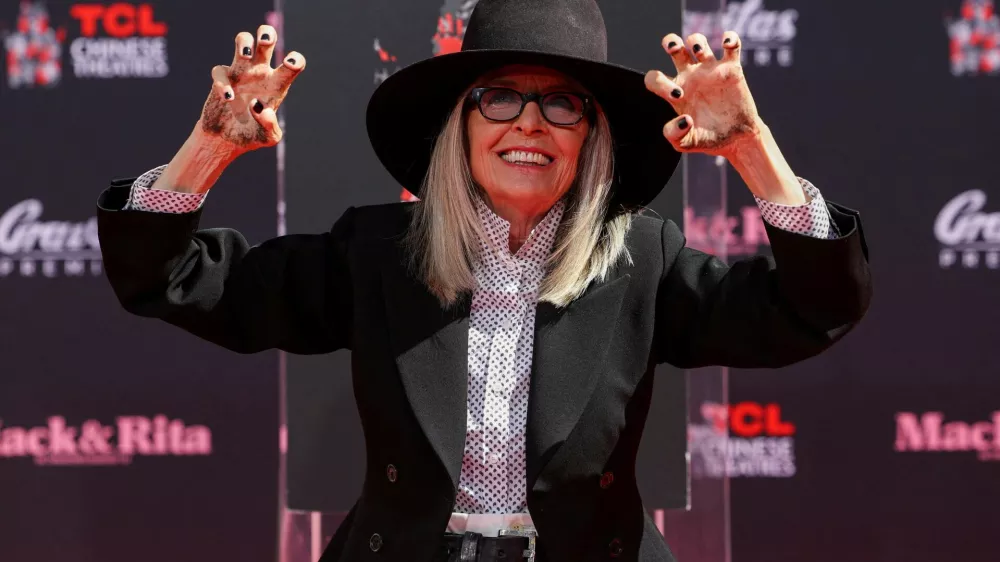 FILE PHOTO: Actor Diane Keaton shows her hands after placing them on fresh cement during a ceremony TCL Chinese theatre in Los Angeles, California, U.S., August 11, 2022. REUTERS/Mario Anzuoni/File Photo