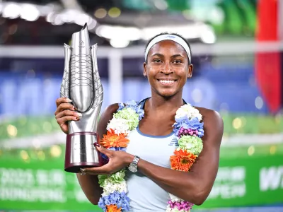 Coco Gauff of the United States celebrates with her trophy after defeating her compatriot Jessica Pegula in the women's singles final at the WTA Wuhan Open in Wuhan in central China's Hubei province Sunday, Oct. 12, 2025. (Chinatopix Via AP) CHINA OUT