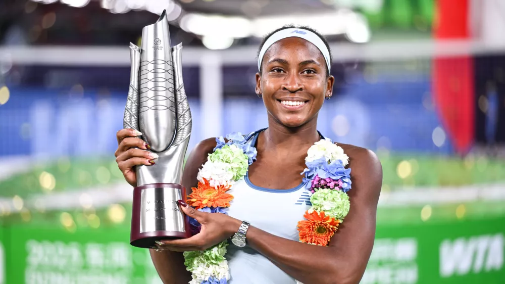 Coco Gauff of the United States celebrates with her trophy after defeating her compatriot Jessica Pegula in the women's singles final at the WTA Wuhan Open in Wuhan in central China's Hubei province Sunday, Oct. 12, 2025. (Chinatopix Via AP) CHINA OUT