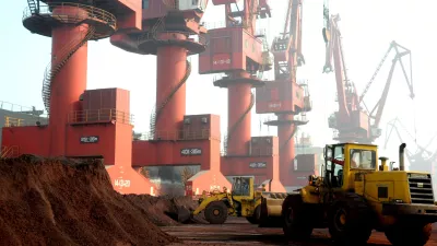FILE PHOTO: Workers transport soil containing rare earth elements for export at a port in Lianyungang, Jiangsu province, China, October 31, 2010. REUTERS/Stringer ATTENTION EDITORS - THIS IMAGE WAS PROVIDED BY A THIRD PARTY. CHINA OUT./File Photo