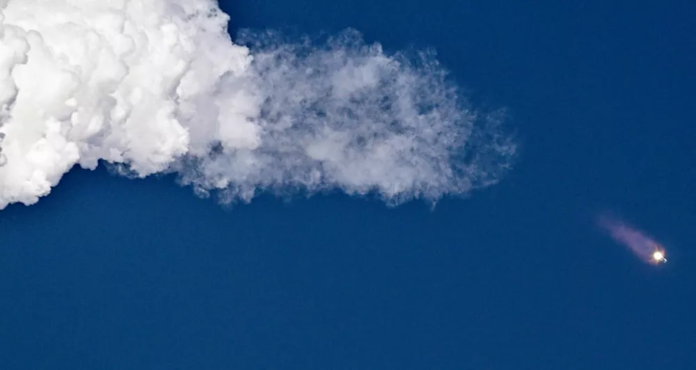 A SpaceX Super Heavy booster carrying the Starship spacecraft lifts off on its 11th test flight at the company's launch pad in Starbase, Texas, U.S., October 13, 2025. REUTERS/Steve Nesius