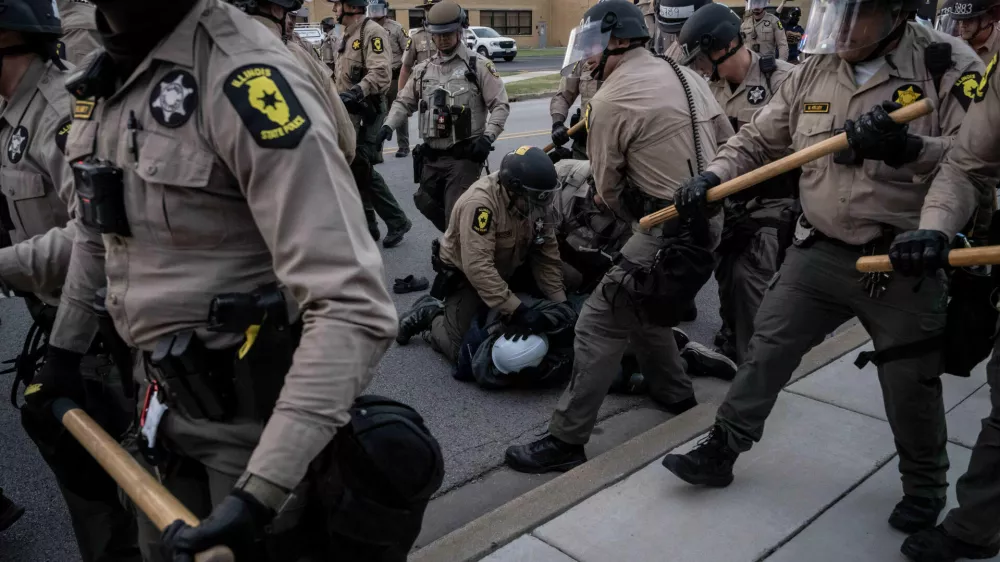 Illinois State Police move in to make detentions after declaring an unlawful assembly outside the U.S. Immigration and Customs Enforcement facility in Broadview, Ill., Saturday, Oct. 11, 2025. (AP Photo/Adam Gray)