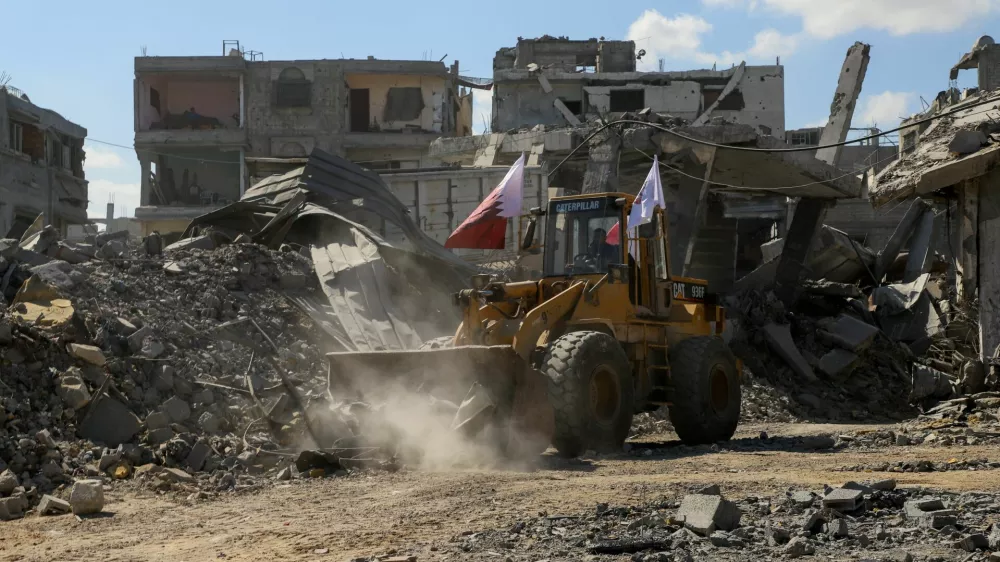 Heavy machinery removes debris from a street, amid a ceasefire between Israel and Hamas, in Gaza City, October 14, 2025. REUTERS/Ebrahim Hajjaj