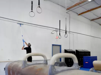 ﻿Southwest Gymnastics Training Center owner Brock Anstine cleans walls in his gym Monday, March 23, 2020, in Tempe, Ariz. Anstine, in compliance with CDC guidelines to help slow the spread of the COVID-19 coronavirus, has closed his gym and is paying his staff to deep cleans and paint the facility during their shut down. (AP Photo/Matt York)