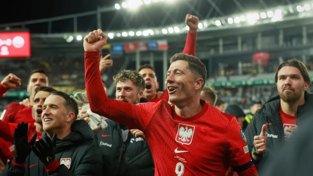 Poland's Robert Lewandowski celebrates with teammates after the World Cup 2026 group G qualifying soccer match between Lithuania and Poland at Darius and Girenas stadium in Kaunas, Lithuania, Sunday, Oct. 12, 2025. (AP Photo/Mindaugas Kulbis)