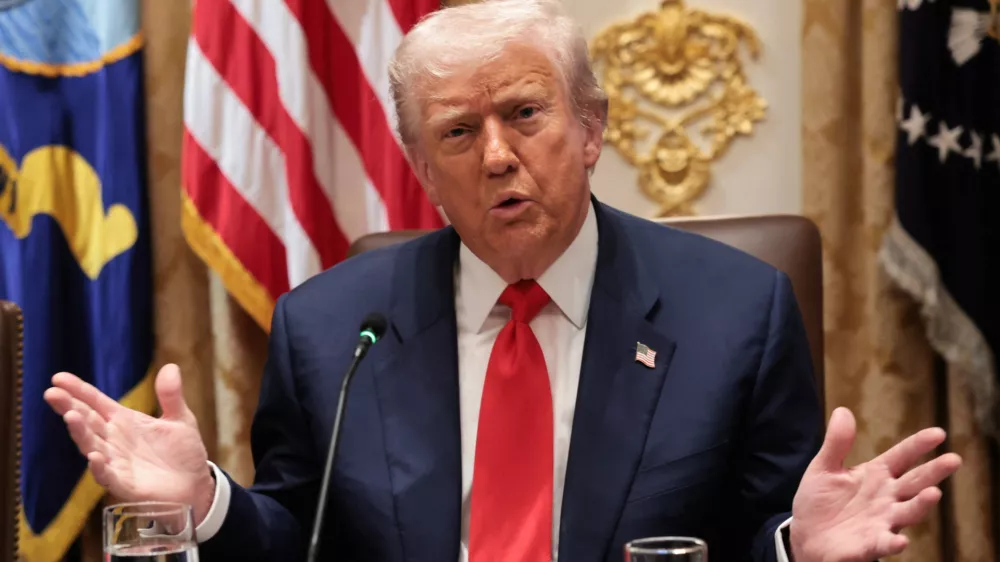 U.S. President Donald Trump gestures as he speaks during lunch with Argentina's President Javier Milei (not pictured) in the Cabinet Room at the White House in Washington, D.C., U.S., October 14, 2025. REUTERS/Jonathan Ernst