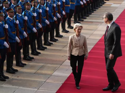 European Commission President Ursula von der Leyen, left, reviews the honor guard with Serbian President Aleksandar Vucic during a welcome ceremony at the Serbia Palace in Belgrade, Serbia, Wednesday, Oct. 15, 2025. (AP Photo/Darko Vojinovic)