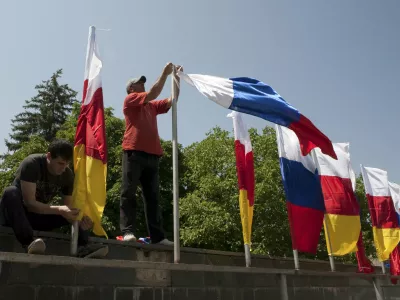 ﻿Men attach flags of South Ossetia and Russia during the preparations for an oath of allegiance military ceremony in Tskhinvali, the capital of the breakaway region of South Ossetia, Georgia, July 5, 2015. President Vladimir Putin signed a treaty with Georgia's rebel South Ossetia region on March 18 that almost completely integrates it with Russia, alarming Georgia and the West a year after Moscow took over Crimea. Russia won a five-day war with Georgia in 2008 over the fate of South Ossetia and another rebel region, Abkhazia. It formally recognizes both regions as independent states and signed a similar treaty with Abkhazia last year. Picture taken July 5, 2015. REUTERS/Kazbek Basaev