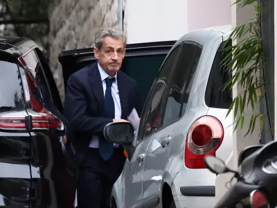 Former French President Nicolas Sarkozy leaves his car as he arrives at his home after being notified of his incarceration date by the National Financial Prosecutor's Office (PNF), following a five-year sentence for criminal conspiracy over attempts to raise campaign funds from Libya, in Paris, France, October 13, 2025. REUTERS/REUTERS/Stephane Mahe