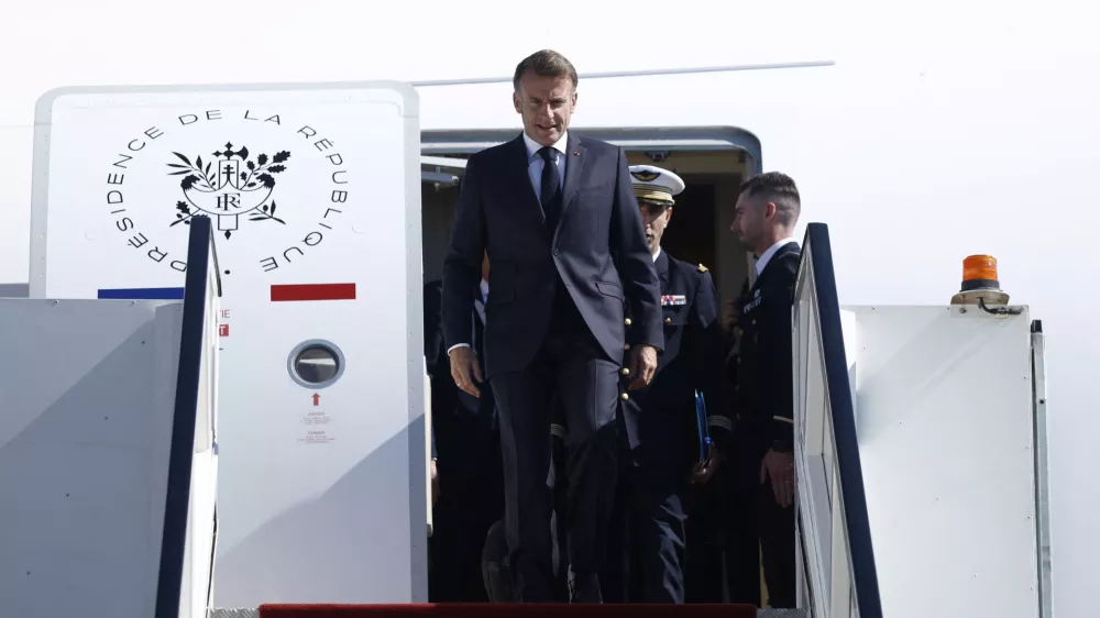 French President Emmanuel Macron arrives by plane to attend the Gaza Peace Summit, in Sharm el-Sheikh, Egypt, October 13, 2025. Yoan Valat/Pool via REUTERS
