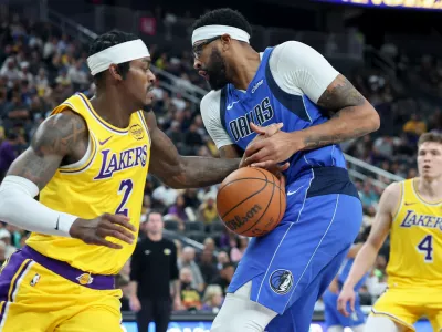 Los Angeles Lakers forward Jarred Vanderbilt (2) knocks the ball away from Dallas Mavericks forward Anthony Davis (3) during the first half of a preseason NBA basketball game Wednesday, Oct. 15, 2025, in Las Vegas. (AP Photo/Ian Maule)