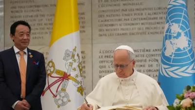 Pope Leo XIV signs a gold book as he attends at the Global World Food Day Ceremony in Rome, Thursday, Oct. 16, 2025. (AP Photo/Alessandra Tarantino)