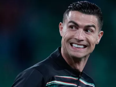 Portugal's Cristiano Ronaldo smiles as he warms up for a World Cup 2026 group F qualifying soccer match between Portugal and Hungary in Lisbon, Tuesday, Oct. 14, 2025. (AP Photo/Armando Franca)