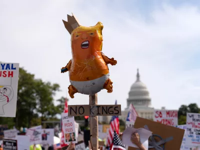 Demonstrators rally on Pennsylvania Avenue during a No Kings protest in Washington, Saturday, Oct. 18, 2025. (AP Photo/Jose Luis Magana)