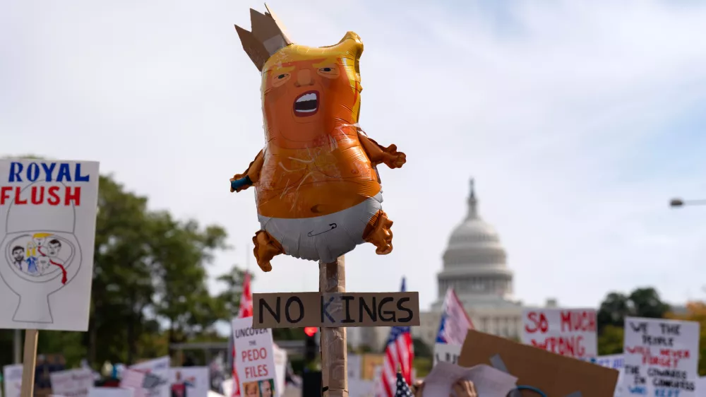 Demonstrators rally on Pennsylvania Avenue during a No Kings protest in Washington, Saturday, Oct. 18, 2025. (AP Photo/Jose Luis Magana)