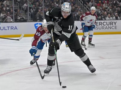 Oct 7, 2025; Los Angeles, California, USA; Los Angeles Kings center Anze Kopitar (11) controls the puck during the second period against the Colorado Avalanche at Crypto.com Arena. Mandatory Credit: Jayne Kamin-Oncea-Imagn Images