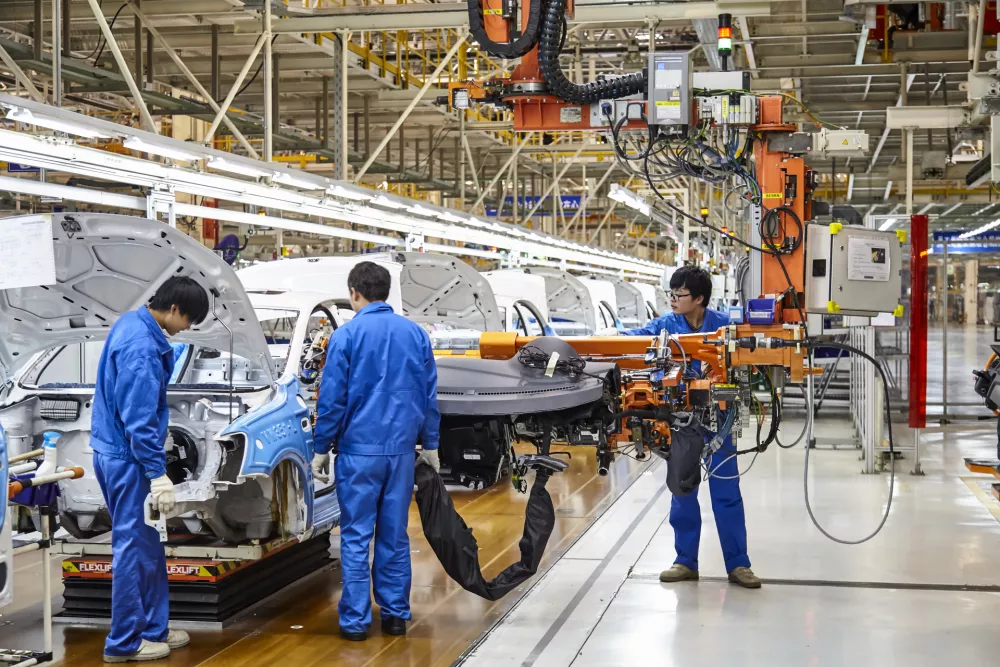 Shanghai, China, China - January 12, 2016: Workers who install and install cars on the Shanghai Volkswagen factory assembly line are busy.