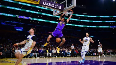Feb 6, 2025; Los Angeles, California, USA; Los Angeles Lakers center Jaxson Hayes (11) dunks for the basket against Golden State Warriors forward Jackson Rowe (44) and guard Pat Spencer (61) during the first half at Crypto.com Arena. Mandatory Credit: Gary A. Vasquez-Imagn Images
