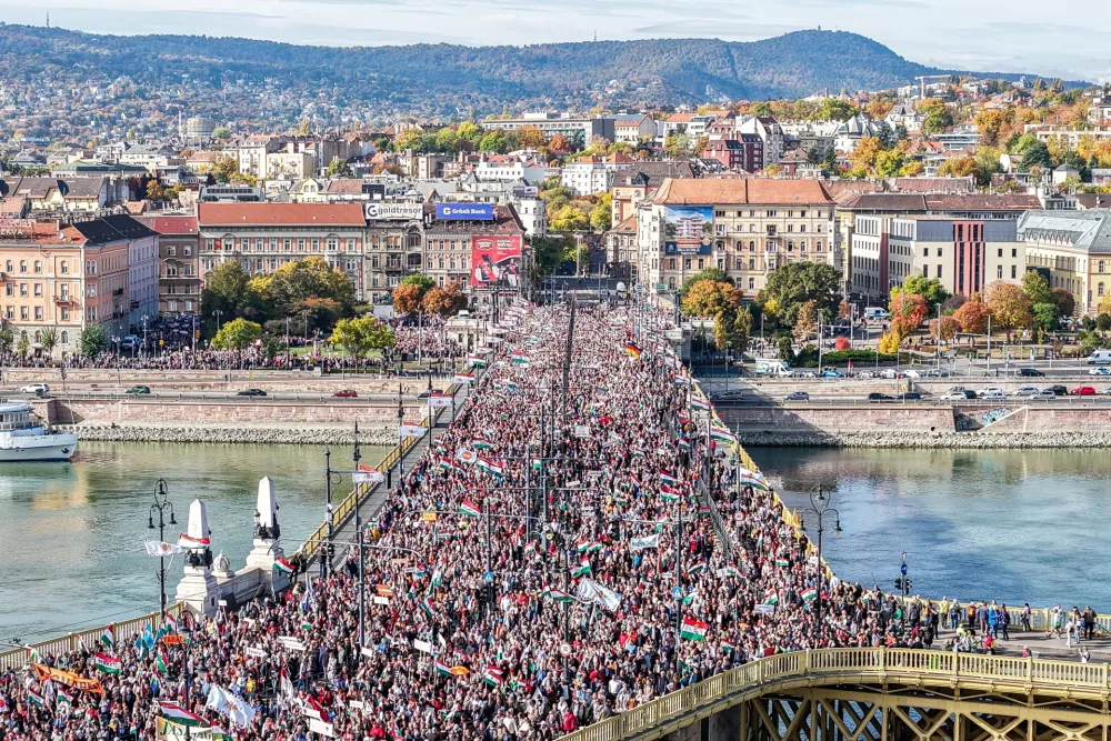 In this picture taken by a drone, participants of the Peace March organized by the pro-government Civil Unity Forum (COF) and its foundation Civil Unity Public Benefit Foundation (COKA) walk on the Margaret Bridge in Budapest, Hungary, Thursday, Oct. 23, 2025, on the 69th anniversary of the Hungarian revolution and war of independence against communist rule and the Soviet Union in 1956. (Zsolt Czegledi /MTI via AP)