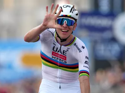 Reigning World Champion Tadej Pogacar indicates five as he celebrates winning his fifth in a row Il Lombardia, Tour of Lombardy cycling race, in Bergamo, Italy, Saturday, Oct. 11, 2025. (Gian Mattia D'Alberto/LaPresse via AP)