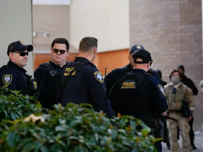 Law enforcement officers are seen outside a United States Immigration and Customs Enforcement (ICE) facility in Portland, Ore., Monday, Oct. 20, 2025. (AP Photo/Jenny Kane)