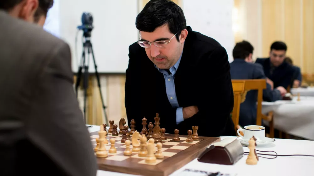 FILE - Russian chess grandmaster Vladimir Kramnik, right, concentrates during his game against U.S. grandmaster Lewon Aronjan during the Zurich Chess Challenge 2015 Round 3 in Zurich, Feb. 16, 2015. (Ennio Leanza/Keystone via AP)