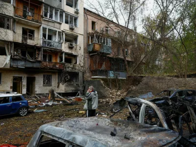A resident talks on a mobile phone near an apartment building which was damaged during an overnight Russian drone strike, amid Russia's attack on Ukraine, in Kyiv, Ukraine October 23, 2025. REUTERS/Valentyn Ogirenko