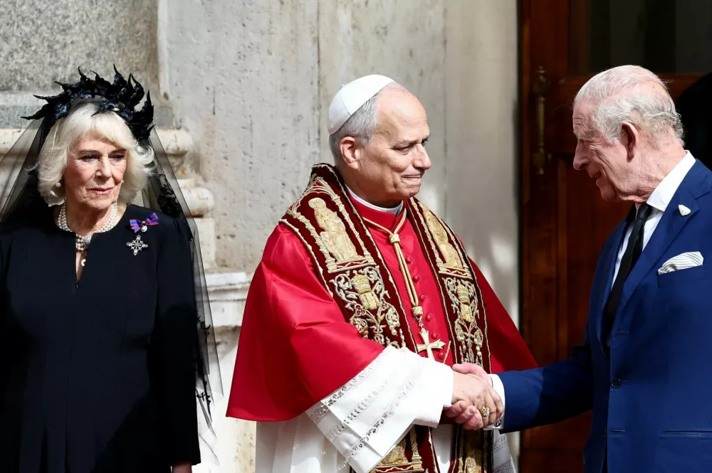 Britain's King Charles shakes hands with Pope Leo XIV in the courtyard of San Damaso, as Queen Camilla stands next to them, following an ecumenical prayer in the Sistine Chapelle led by the Pope and Archbishop of York Stephen Cottrell, at the Vatican, October 23, 2025. REUTERS/Yara Nardi