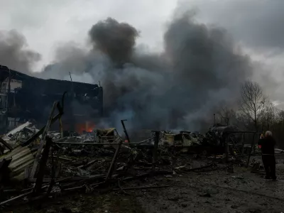 A resident takes a picture of the site of food warehouses hit by an overnight Russian missile strike, amid Russia's attack on Ukraine, in Kyiv, Ukraine October 25, 2025. REUTERS/Valentyn Ogirenko