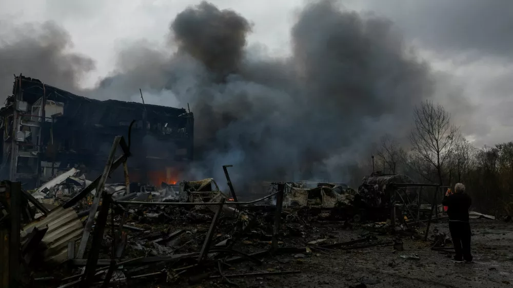 A resident takes a picture of the site of food warehouses hit by an overnight Russian missile strike, amid Russia's attack on Ukraine, in Kyiv, Ukraine October 25, 2025. REUTERS/Valentyn Ogirenko