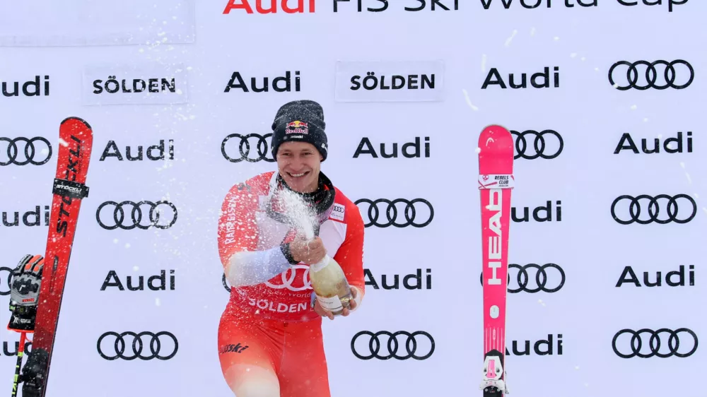 Alpine Skiing - FIS Alpine Ski World Cup - Men's Giant Slalom - Soelden, Austria - October 26, 2025 Switzerland's Marco Odermatt celebrates on the podium with champagne after placing first REUTERS/Leonhard Foeger