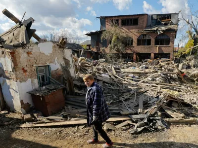 Oksana Lavrenteva, 52, walks past rubble of her house following what Russian-installed authorities described as an overnight Ukrainian missile strike, amid the Russia-Ukraine military conflict in Yasynuvata (Yasinovataya) in the Donetsk region, a Russian-controlled area of Ukraine, October 26, 2025. REUTERS/Alexander Ermochenko
