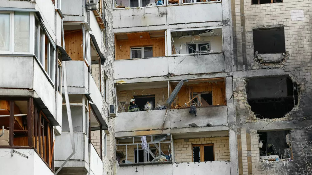Rescuers work inside an apartment building damaged during an overnight Russian drone strike, amid Russia's attack on Ukraine, in Kyiv, Ukraine October 26, 2025. REUTERS/Valentyn Ogirenko