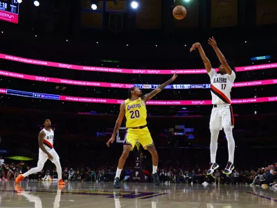 Portland Trail Blazers guard Shaedon Sharpe (17) shoots the ball against Los Angeles Lakers guard Nick Smith Jr. (20) during the second half of an NBA basketball game Monday, Oct. 27, 2025, in Los Angeles. (AP Photo/Ethan Swope)