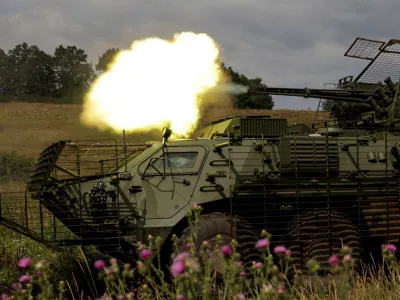 Service members of the 58th Separate Motorized Infantry Brigade of the Ukrainian Armed Forces fire a cannon of a BTR-4 armoured personnel carrier during military exercises at a training ground, amid Russia's attack on Ukraine, in Kharkiv region, Ukraine August 11, 2025. REUTERS/Sofiia Gatilova