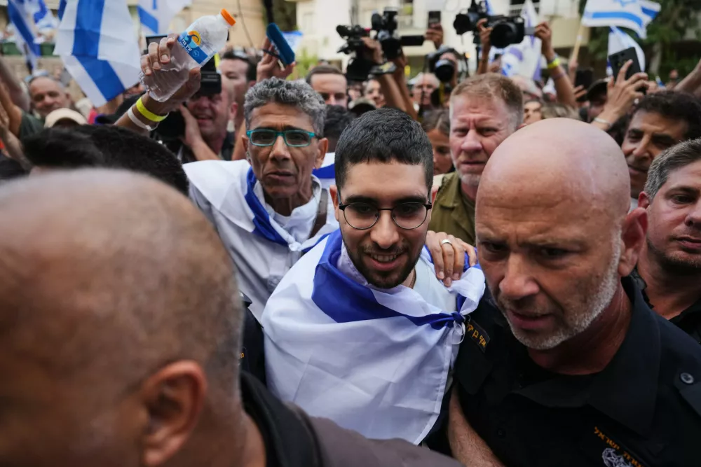 Freed Israeli hostage Evyatar David, center, who was recently released from Hamas captivity in Gaza, is welcomed home as he returns from the hospital to Kfar Saba, Israel, Sunday, Oct. 26, 2025. (AP Photo/Ariel Schalit)