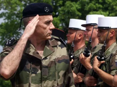 French army chief-of-staff General Jean Pierre Kelche (L) salutes as he visits a French Foreign legion unit at the military field near Kumanovo, some 40 kms north-east of Skopje, April 30. Unidentified assailants threw a hand granade at a French NATO army jeep late on Thursday, a NATO official said. There were no casualties reported.OP/