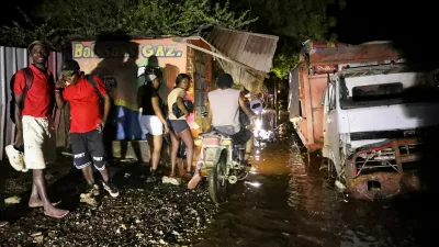 People walk along a street after floods caused by the outer bands of Hurricane Melissa killed several people, in Petit Goave, Haiti, October 29, 2025. REUTERS/Egeder Pq Fildor