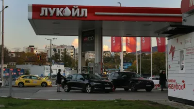 A person is seen refueling a car at a Lukoil petrol station Lukoil in Sofia, Bulgaria, Tuesday, Oct. 28, 2025. (AP Photo/ Valentina Petrova)
