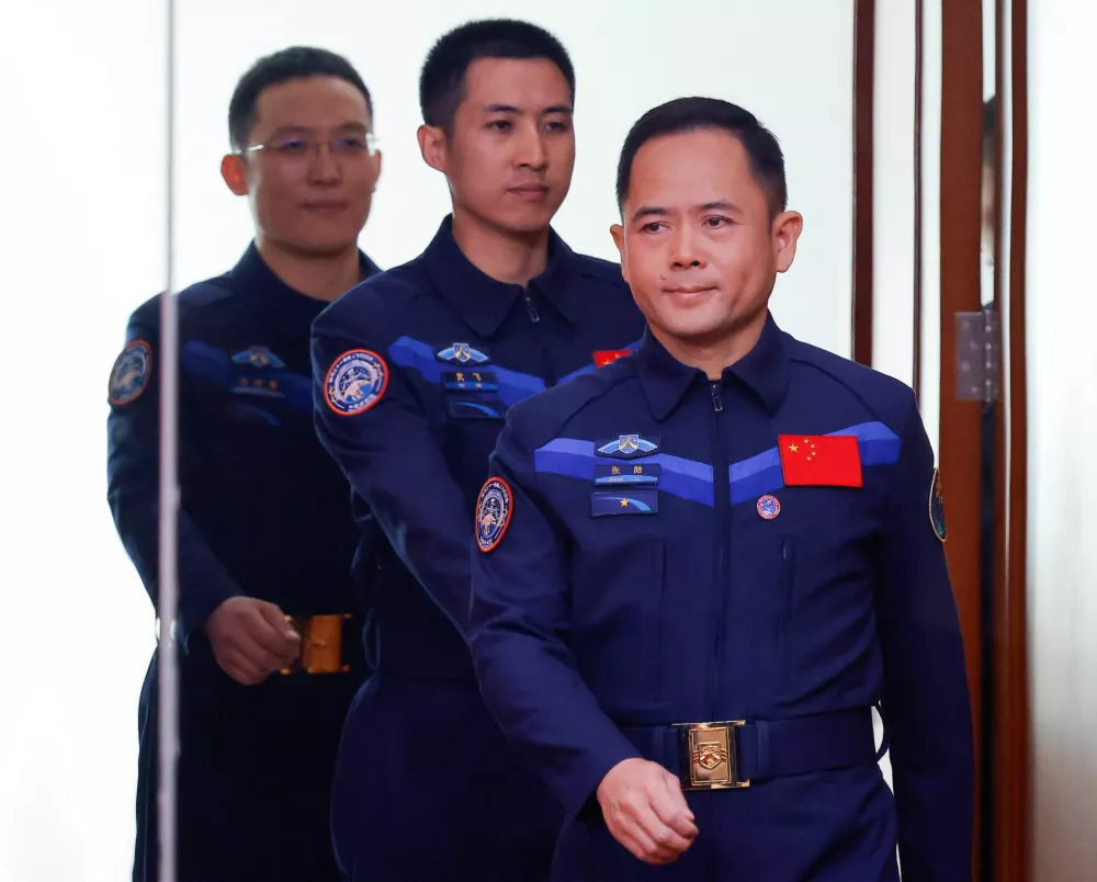 Astronauts Zhang Lu, Wu Fei, and Zhang Hongzhang arrive at a press conference before the Shenzhou-21 spaceflight mission to China's Tiangong space station, at Jiuquan Satellite Launch Center, near Jiuquan, Gansu province, China, October 30, 2025. REUTERS/Maxim Shemetov