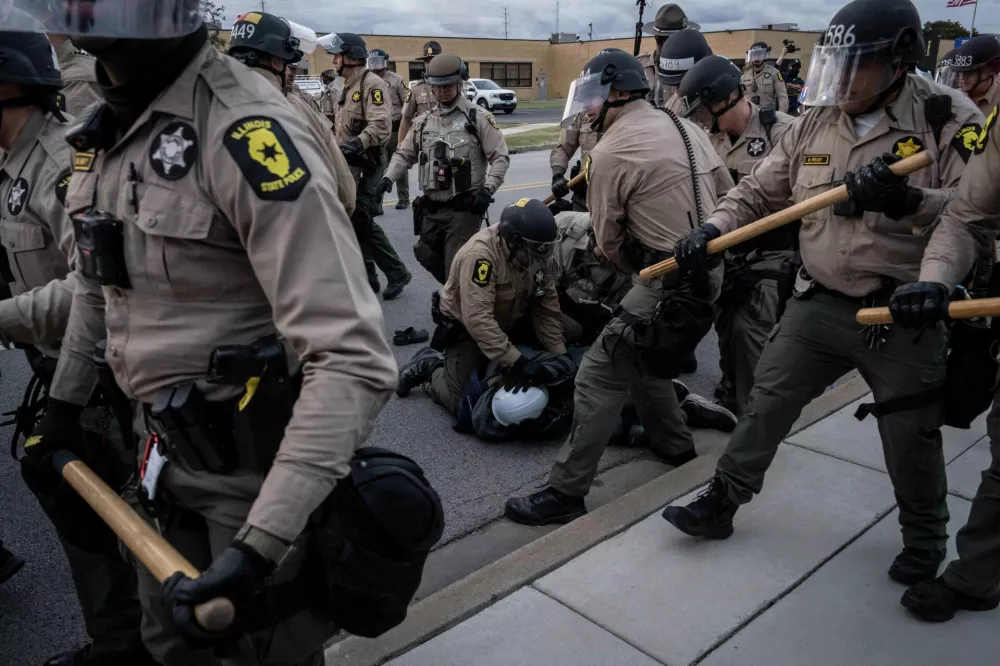 Illinois State Police move in to make detentions after declaring an unlawful assembly outside the U.S. Immigration and Customs Enforcement facility in Broadview, Ill., Saturday, Oct. 11, 2025. (AP Photo/Adam Gray)