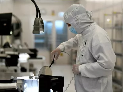 FILE PHOTO: An employee works with a wafer in a production line of Dutch semiconductor company Nexperia, in Hamburg, Germany, June 27, 2024. REUTERS/Fabian Bimmer/File Photo