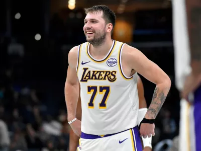 Los Angeles Lakers guard Luka Doncic (77) reacts in the second half of an NBA Cup basketball game against the Memphis Grizzlies Friday, Oct. 31, 2025, in Memphis, Tenn. (AP Photo/Brandon Dill)