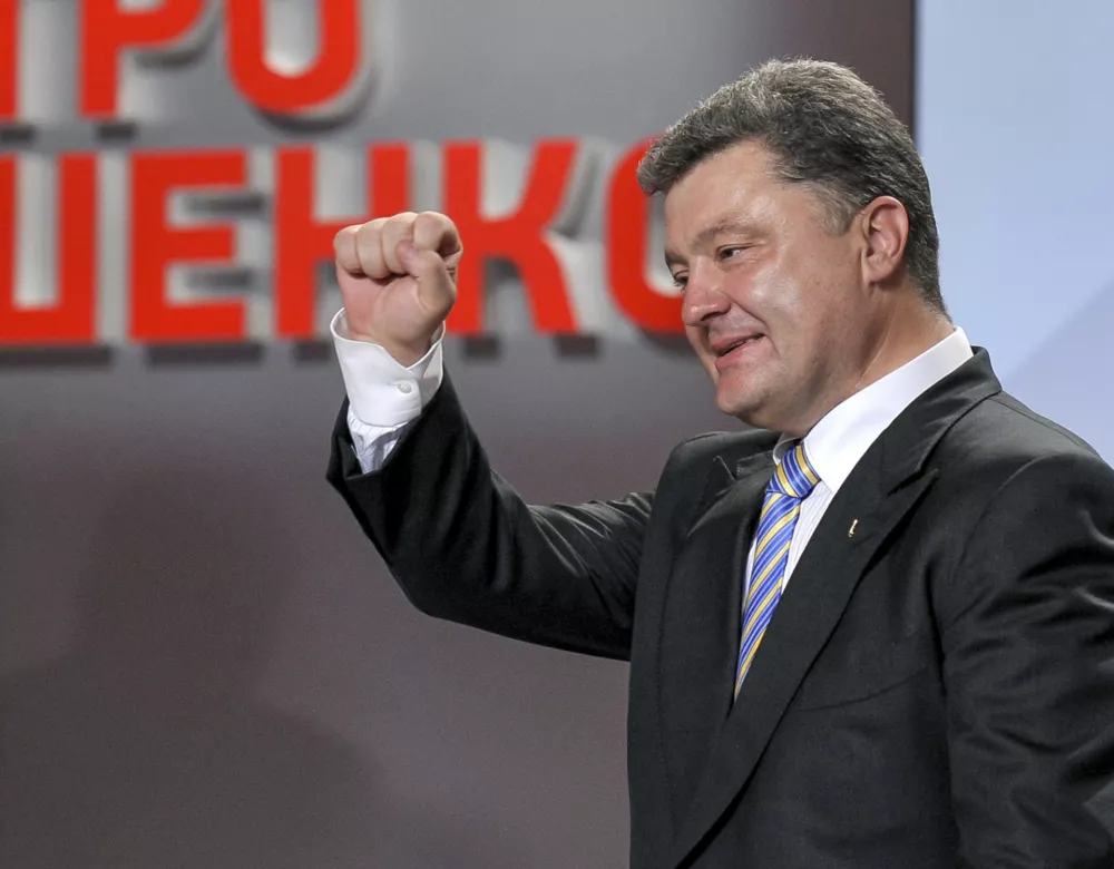 ﻿Ukrainian presidential candidate Petro Poroshenko reacts during his press conference in Kiev, Ukraine, Sunday, May 25, 2014. An exit poll showed that billionaire candy-maker Petro Poroshenko won Ukraine's presidential election outright Sunday in the first round — a vote that authorities hoped would unify the fractured nation. (AP Photo/Mykola Lazarenko, Pool)