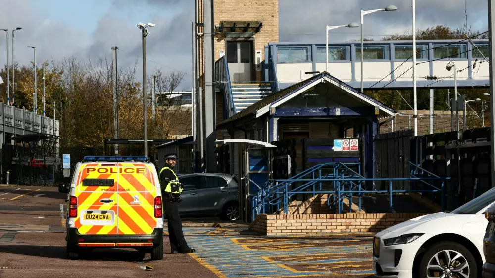 A police officer stands next to a police vehicle at Huntingdon Station, following a series of stabbings on a London North Eastern Railway (LNER) train, near Cambridge, Britain, November 2, 2025. REUTERS/Jack Taylor