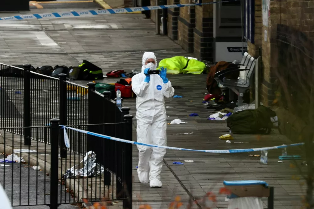 A forensic officer works at the scene at Huntingdon Station following a series of stabbings on a train, near Cambridge, Britain, November 2, 2025. REUTERS/Jack Taylor