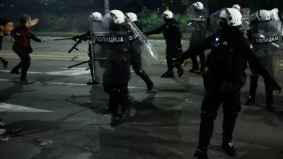 Serbian riot police separate rival crowds of opponents, right, and loyalists of autocratic President Aleksandar Vucic, a day after tens of thousands of people joined a huge rally in the northern city of Novi Sad marking the first anniversary of a train station disaster there that killed 16 people, in Belgrade, Serbia, Sunday, Nov. 2, 2025. (AP Photo/Marko Drobnjakovic)