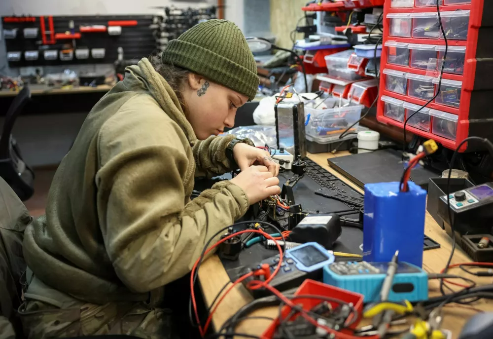 A servicewoman from the SQUADRON interceptor unit of the 3rd Army Corps of the Ukrainian Armed Forces works in a drone workshop, amid Russia's attack on Ukraine, near the frontline in eastern Ukraine, October 30, 2025. REUTERS/Anatolii Stepanov