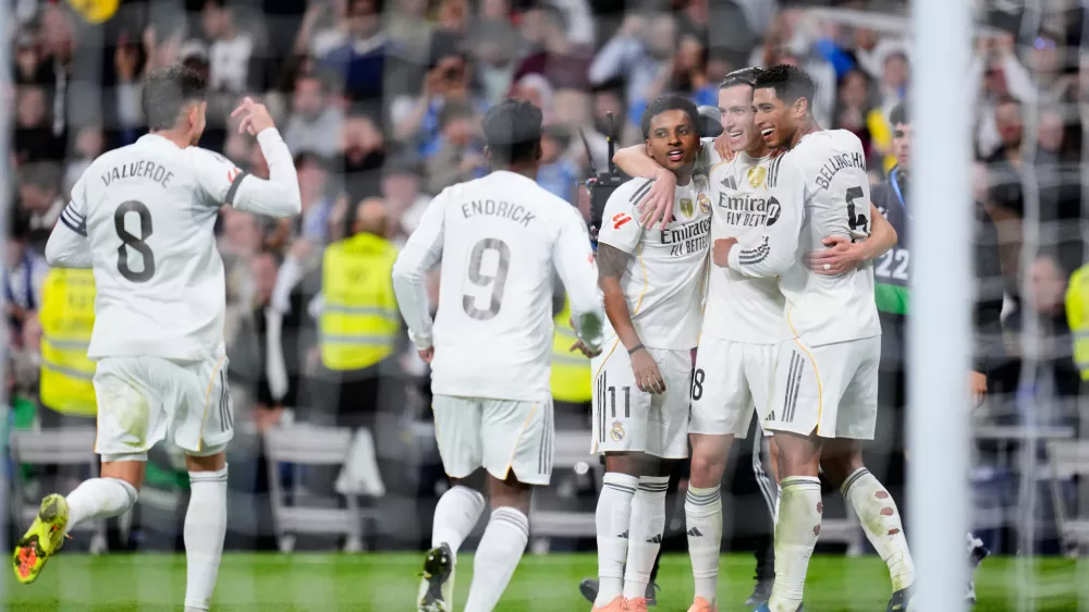 Real Madrid's Alvaro Carreras, second from right, celebrates after scoring his side's fourth goal with from left: Federico Valverde, Endrick, Rodrygo and Jude Bellingham, right, during the Spanish La Liga soccer match between Real Madrid and Valencia in Madrid, Spain, Saturday, Nov. 1, 2025. (AP Photo/Manu Fernandez)